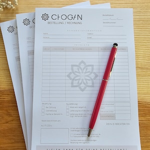 May include: A white order form with the text "CHOGAN BESTELLUNG / RECHNUNG" at the top. The form has sections for customer information, products, payment, and delivery. The form also includes a section for notes and a space for the customer's consultant's name.