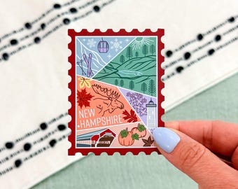 May include: A rectangular sticker shaped like a postage stamp with a dark red border. The design is divided into four sections featuring illustrations of New Hampshire, including a moose, a covered bridge, pumpkins, a lighthouse, and ski gear.