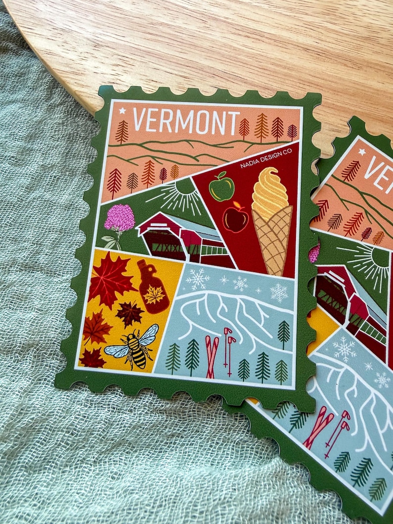 May include: A green-edged sticker with a Vermont theme, featuring illustrations of a red barn, apples, an ice cream cone, maple syrup, a bee, and skiers. The word "VERMONT" is at the top.