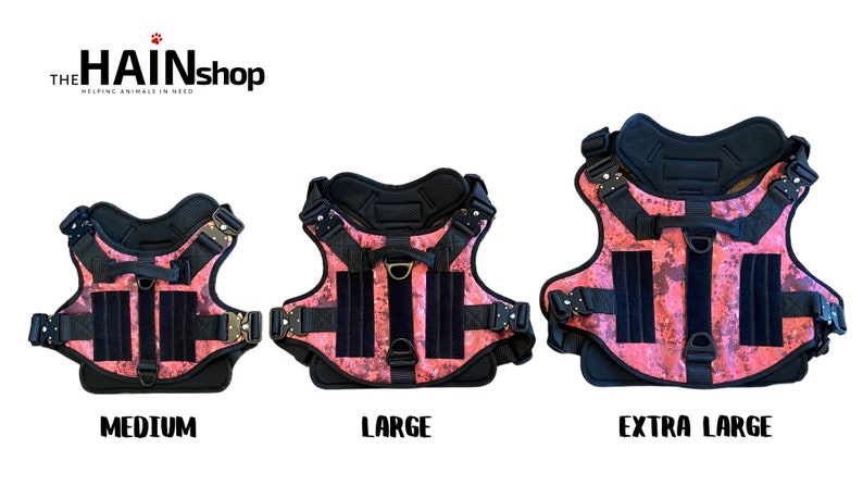 May include: Three pink and black dog harnesses with adjustable straps and buckles. The harnesses are labeled "Medium", "Large", and "Extra Large".