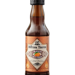 May include: A 200 ml bottle of The Bitter Truth Orange Bitters, a cocktail flavoring. The bottle is brown glass with a black cap and a label with an orange and the text "The Bitter Truth Orange Bitters Cocktail Flavoring".