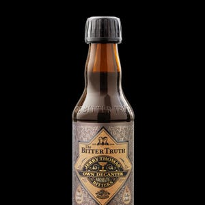 May include: A brown glass bottle of Jerry Thomas Own Decanter Aromatic Bitters with a black cap. The label features the text "The Bitter Truth" and "Jerry Thomas". The bottle contains 200 ml of liquid.