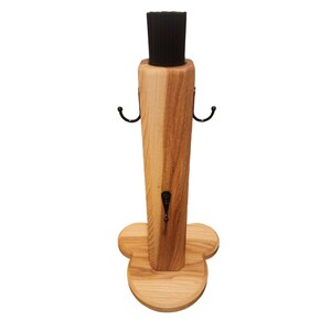 May include: Wooden stand with a black brush and three hooks. The stand has a heart-shaped base.