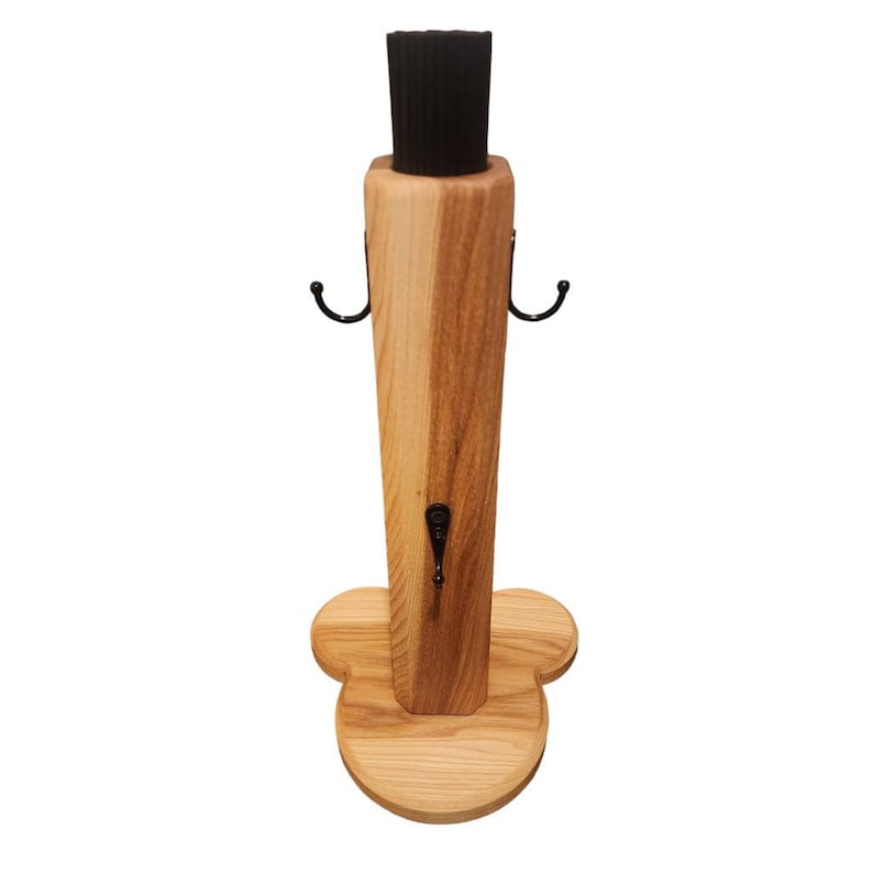 May include: Wooden stand with a black brush and three hooks. The stand has a heart-shaped base.