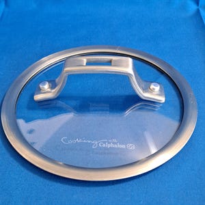 May include: A set of three ceramic nesting bowls in shades of blue, green, and white. The bowls feature a speckled glaze and a simple, modern design. The largest bowl measures approximately 6 inches in diameter.