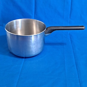 May include: A stainless steel saucepan with a cylindrical body and a smooth, metallic finish. The pot features a single, long, black heat-resistant handle attached to the side, with a small circular hole at the end for convenient hanging storage.