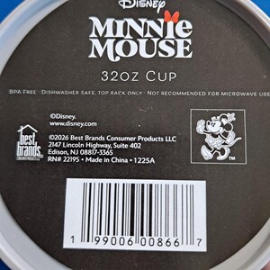 May include: A black and white label featuring the Disney Minnie Mouse logo and text. The label states "32OZ CUP" and includes the text "BPA FREE DISHWASHER SAFE, TOP RACK ONLY NOT RECOMMENDED FOR MICROWAVE USE". A barcode is visible at the bottom.