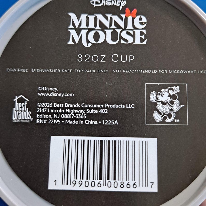 May include: A black and white label featuring the Disney Minnie Mouse logo and text. The label states "32OZ CUP" and includes the text "BPA FREE DISHWASHER SAFE, TOP RACK ONLY NOT RECOMMENDED FOR MICROWAVE USE". A barcode is visible at the bottom.