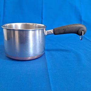 May include: A set of three ceramic mugs with a speckled, matte finish in cream, light grey, and dark grey. Each mug has a simple, minimalist design, ideal for coffee or tea.