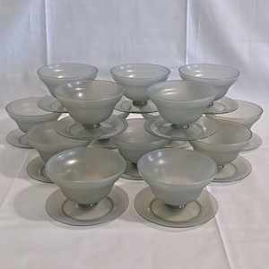 May include: A set of 12 frosted glass dessert bowls with matching plates. The bowls are stacked in a pyramid shape, with the plates underneath.