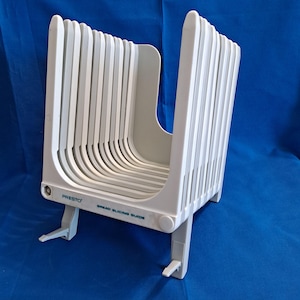 May include: A set of three ceramic nesting bowls in shades of blue, green, and white. The bowls feature a speckled glaze and a simple, modern design. The largest bowl is approximately 7 inches in diameter.