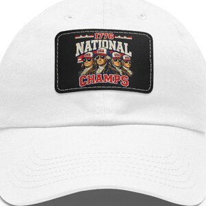 May include: A white baseball cap featuring a rectangular black patch on the front. The patch displays a graphic of four historical figures wearing red, white, and blue USA hats and sunglasses, with the text 1776 NATIONAL CHAMPS in red and white.
