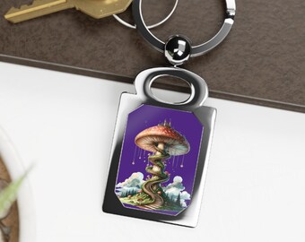 May include: A silver-toned rectangular keyring featuring a central graphic of a large, red-capped mushroom with a winding staircase wrapped around its stem, set against a deep purple background with small hanging lights and a landscape below.