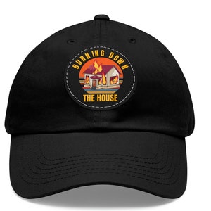 May include: Black baseball cap with a circular patch showing a house on fire. The patch has the words "BURNING DOWN THE HOUSE" in orange and white, set against a sunset background.