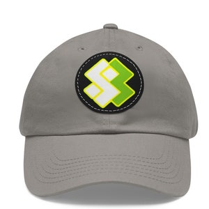 May include: A gray baseball cap with a black, white, and green logo patch. The logo is a stylized geometric design.
