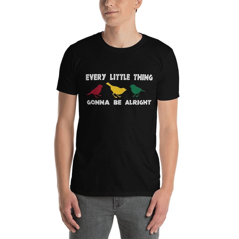May include: Black t-shirt with white text that reads "Every little thing gonna be alright". Three stylized birds are shown in red, yellow, and green.