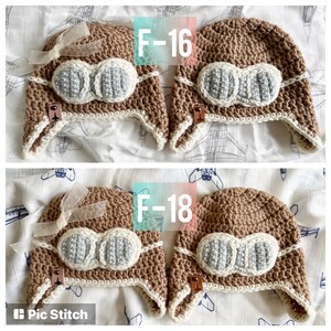 May include: Two brown crocheted aviator hats with white trim and gray felt goggles. The hats are labeled "F-16" and "F-18".