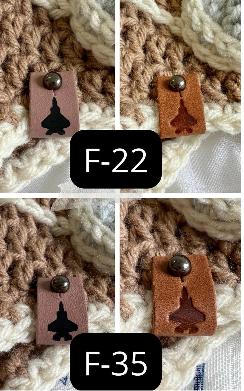 May include: Two sets of brown leather tags with a black metal button and a silhouette of a fighter jet. The tags are labeled "F-22" and "F-35".