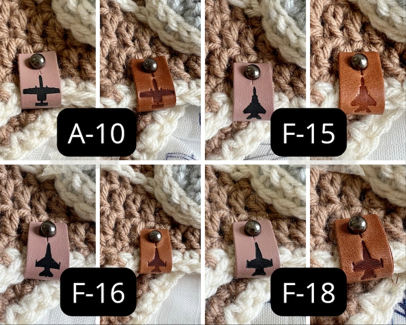 May include: Close-up of four crocheted squares with leather patches featuring different fighter jet silhouettes. The patches are labeled A-10, F-15, F-16, and F-18.
