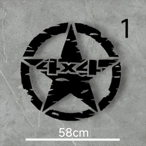May include: Black metal wall art featuring a star within a circle, with the text "4X4" in the center. The design has a distressed, rugged look. The piece measures 58cm (22.8 inches) across and includes the number "1" in the upper right corner.