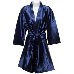 May include: A navy blue satin robe with a self-tie sash. The robe has long sleeves and a V-neck.
