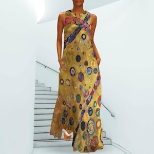 May include: A sleeveless floor-length maxi dress in a golden yellow hue featuring a repeating pattern of multicolored circles and geometric shapes. The garment has a V-neckline and a loose, flowing silhouette that extends to the ankles.