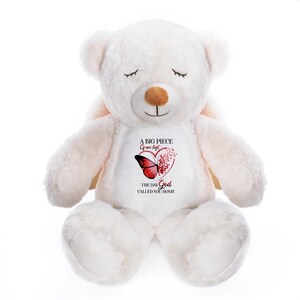 May include: A white plush teddy bear with closed eyes and a brown nose. The bear has a heart-shaped graphic on its chest with a red butterfly and the text "A BIG PIECE of me left, THE DAY God CALLED YOU HOME."