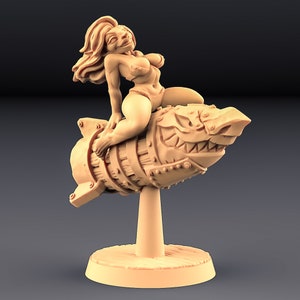 May include: A miniature figurine of a female figure riding a rocket-shaped object with a toothy grin. The figure is wearing a bikini top and bottom. The rocket is detailed with metal accents and a wooden barrel.