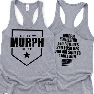 May include: A heather gray tank top with the text "THIS IS MY MURPH SHIRT" in black. The back of the tank top lists the Murph workout: 1 mile run, 100 pull-ups, 200 push-ups, 300 air squats, and 1 mile run, with an American flag.