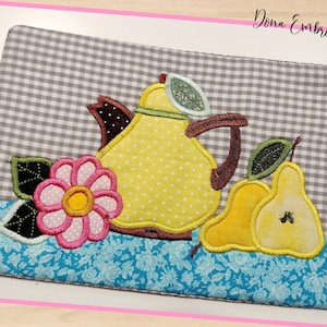 May include: A gray and white checkered fabric coaster with a yellow teapot, pink flower, and two yellow pears. The text "Dona Embroidery Shop" is in the top right corner.
