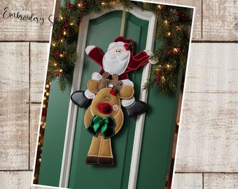 May include: A Christmas door decoration featuring Santa Claus riding a reindeer. The Santa figure is red and white, and the reindeer is brown with a red nose and green bow. The decoration hangs on a green door with a festive garland.