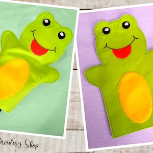 May include: Green felt frog hand puppet with a red tongue and yellow felt belly. The puppet is on a green and purple background.