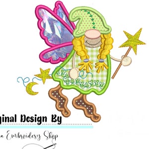 May include: Embroidered design of a gnome fairy with pink wings, a green hat, and a yellow wand. The gnome fairy is wearing a green and white checked dress and has yellow hair. The design includes a crescent moon and stars.