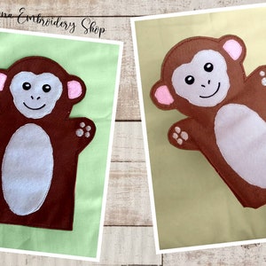 Può includere: Marionetta di scimmia di feltro marrone con orecchie rosa e viso bianco. La marionetta ha una pancia bianca e mani marroni con impronte di zampe bianche.