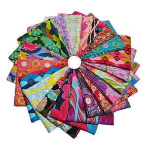 May include: A collection of colorful fabric squares arranged in a circular pattern. The fabrics feature a variety of floral, geometric, and abstract designs in shades of pink, orange, green, blue, and purple. The arrangement creates a vibrant and eye-catching display.