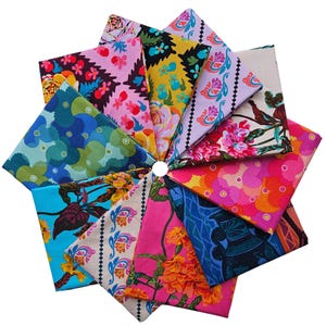 May include: A circular arrangement of folded fabric squares, showcasing a variety of floral and patterned designs. The fabrics feature vibrant colours such as pink, blue, yellow, and orange. The display presents a visually appealing collection of textiles.
