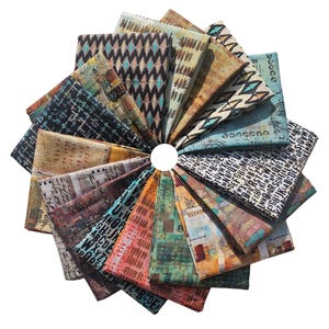 May include: A collection of folded fabric squares arranged in a circular pattern. The fabrics feature various abstract designs, including geometric patterns, text, and watercolor-like textures in shades of blue, brown, green, and red.