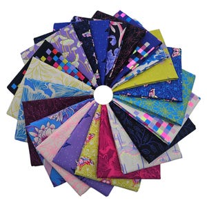 May include: A collection of patterned fabric squares arranged in a circular pattern. The fabrics feature diverse designs, including floral, geometric, and abstract patterns in shades of blue, purple, pink, and green. The arrangement is centered on a white circle.