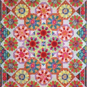 May include: A colorful quilt with a floral pattern. The quilt features large, stylized flowers in shades of red, pink, yellow, and green, set against a light blue background. The design is symmetrical, with a central diamond shape and repeating floral motifs.