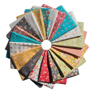 May include: A collection of folded fabric squares arranged in a circular pattern. The fabrics feature various floral and patterned designs in colors like teal, yellow, red, and gray. The arrangement creates a fan-like display, showcasing the variety of textiles.