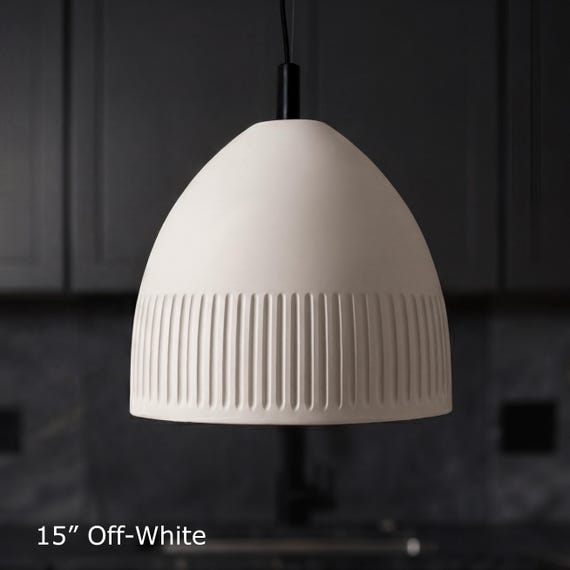 A hand-etched ceramic pendant light in terracotta or white clay is a genuinely rare intersection of pottery craft and functional lighting — the kind of piece that anchors a whole room.