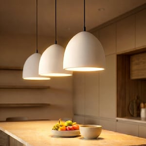 Naaya Dome ceramic pendant lights two white clay over kitchen island dining room warm ambient glow handmade satin matte plug in hardwired