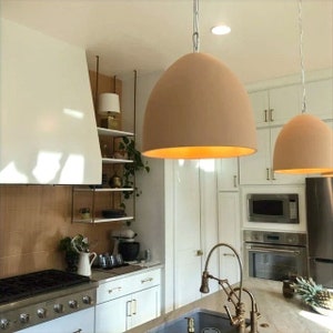 Terracotta organic ceramic dome shaped pendant lights over kitchen island