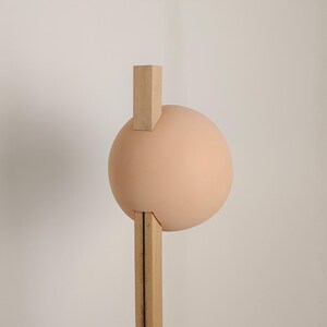 Stuck floor lamp blends artistic design with practical lighting for contemporary living spaces.