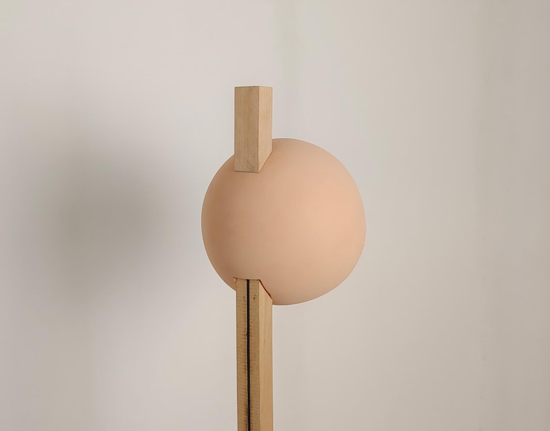 Stuck floor lamp blends artistic design with practical lighting for contemporary living spaces.