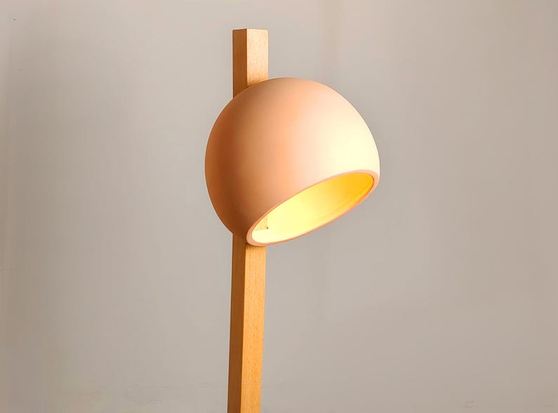 Tall Naaya Stuck lamp offers focused lighting with an artistic clay and wood construction.