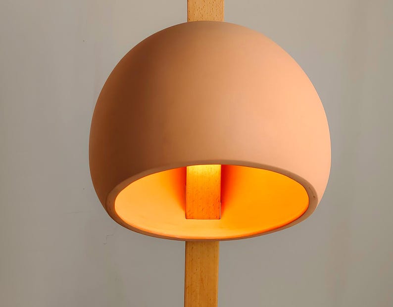 Stuck floor lamp features a wooden pierce-through design for modern, statement-worthy interiors.