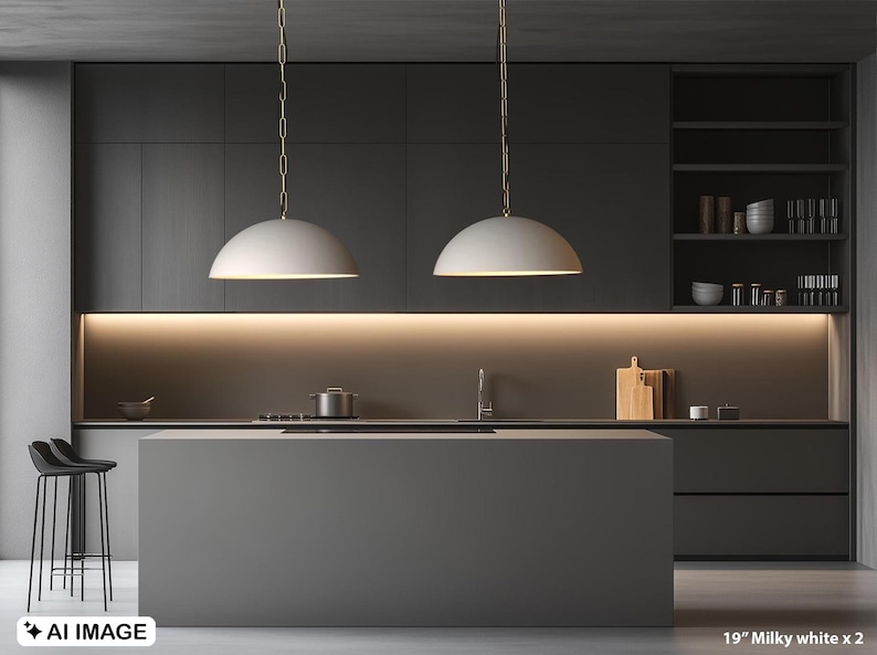 May include: A modern kitchen with dark gray cabinetry and a large island. Two milky white pendant lights hang above the island. The image includes a sink, stove, and shelving with kitchenware. The text in the image reads "19" Milky white x 2".