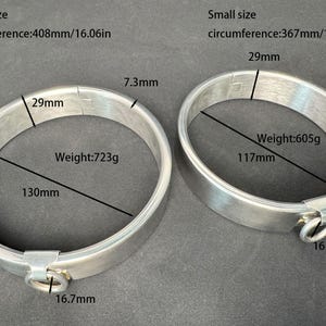 May include: Two silver-toned metal collars with attached rings. Large size: 16.06in circumference, 130mm diameter, 7.3mm width, 29mm height, 723g weight. Small size: 14.45in circumference, 117mm diameter, 6.6mm width, 29mm height, 605g weight.
