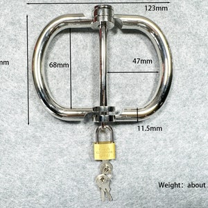May include: A polished metal restraint device with a padlock and keys. The device measures 123mm wide, 92mm high, and 68mm across the opening. The opening is 47mm wide and 11.5mm thick. The weight is about 290g.